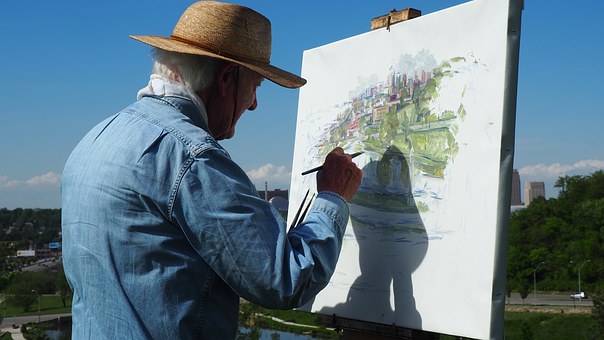 elderly man painting outside